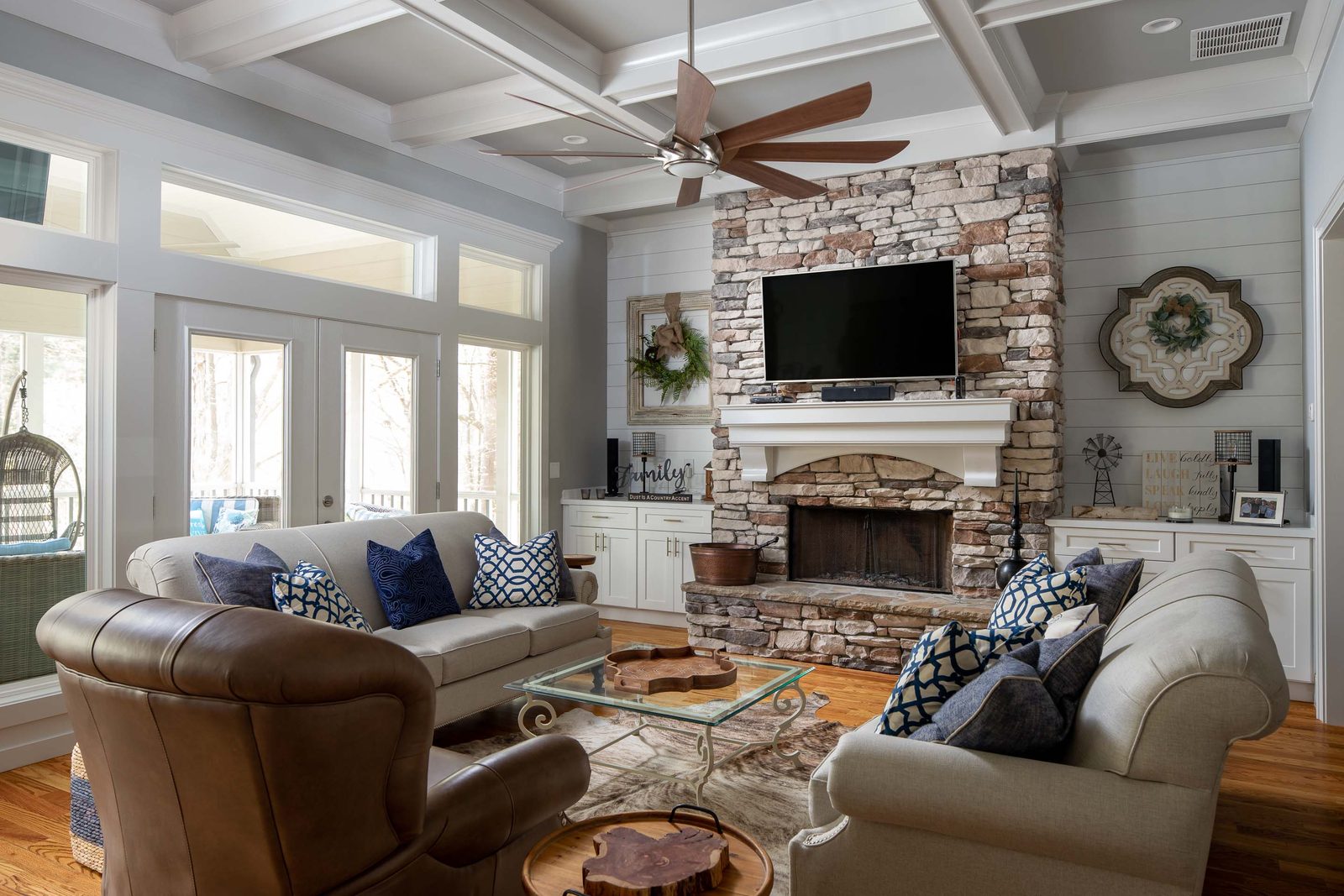 Great room with stacked-stone fireplace and coffered ceiling — Imbriale, custom home built by Ironwood Construction Group