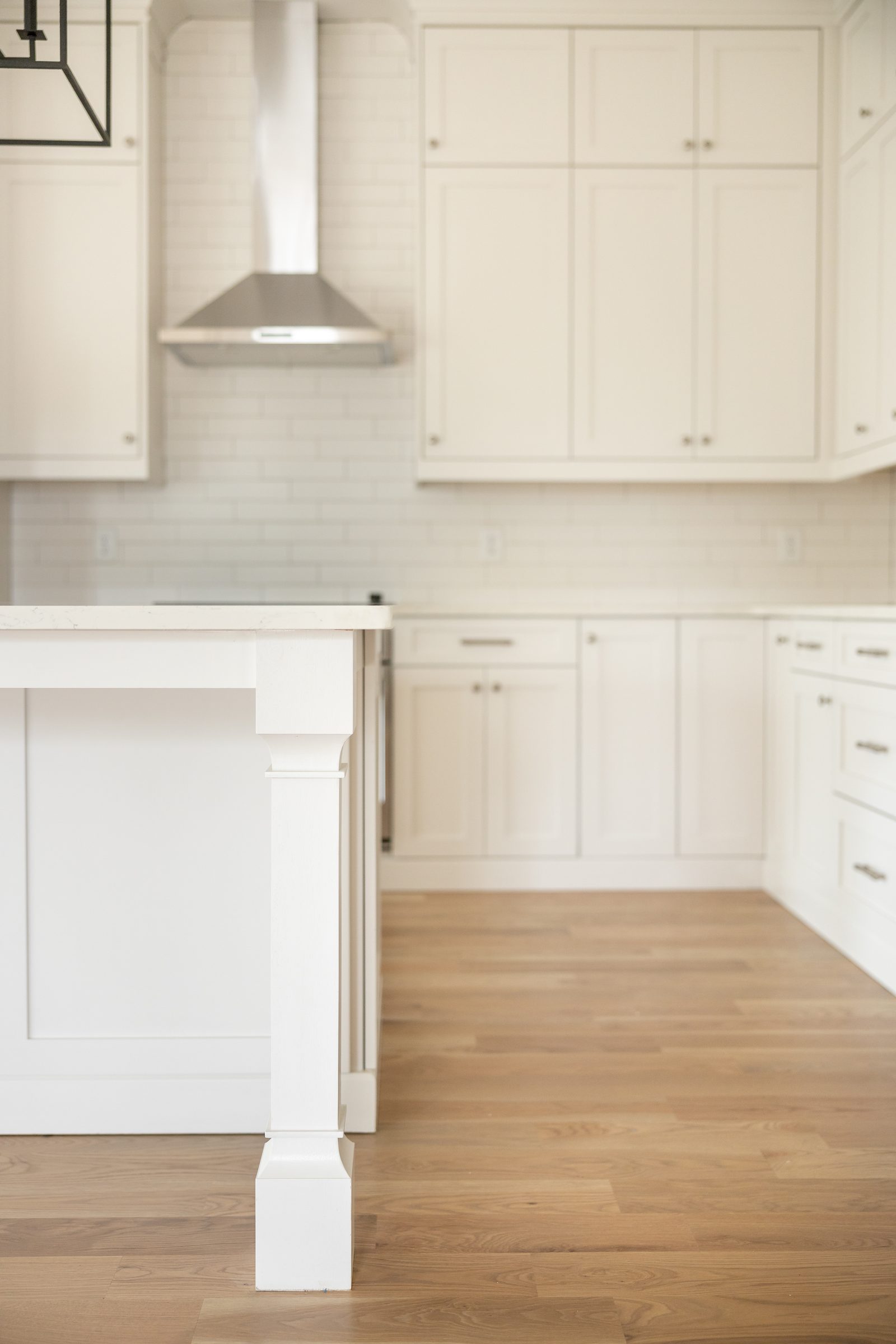 Kitchen island and perimeter cabinetry on white-oak floor — Shadburn Ferry, custom home built by Ironwood Construction Group in Buford, Georgia