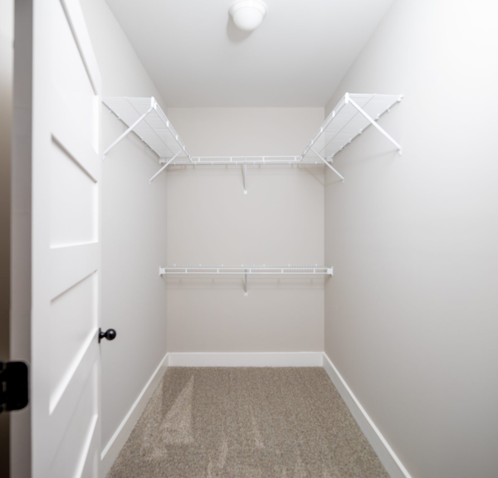 Walk-in closet with wire shelving — Shadburn Ferry, custom home built by Ironwood Construction Group in Buford, Georgia